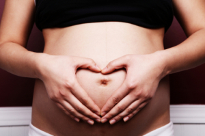 Image of pregnant belly with hands